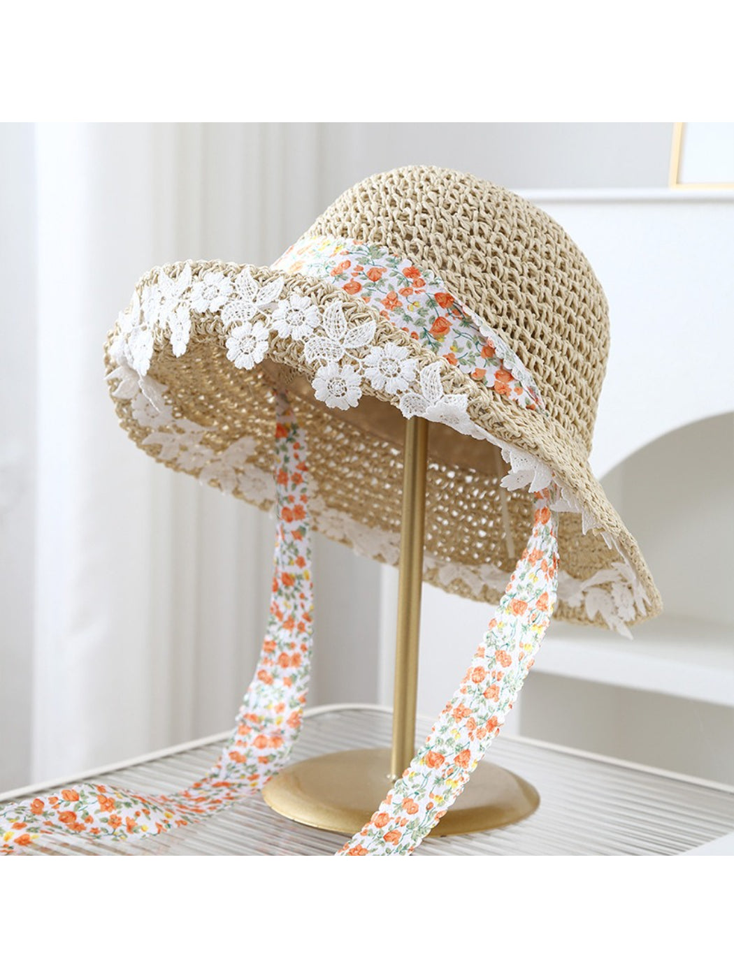 Close-up of Haila bucket hat highlighting lace trim and floral band design