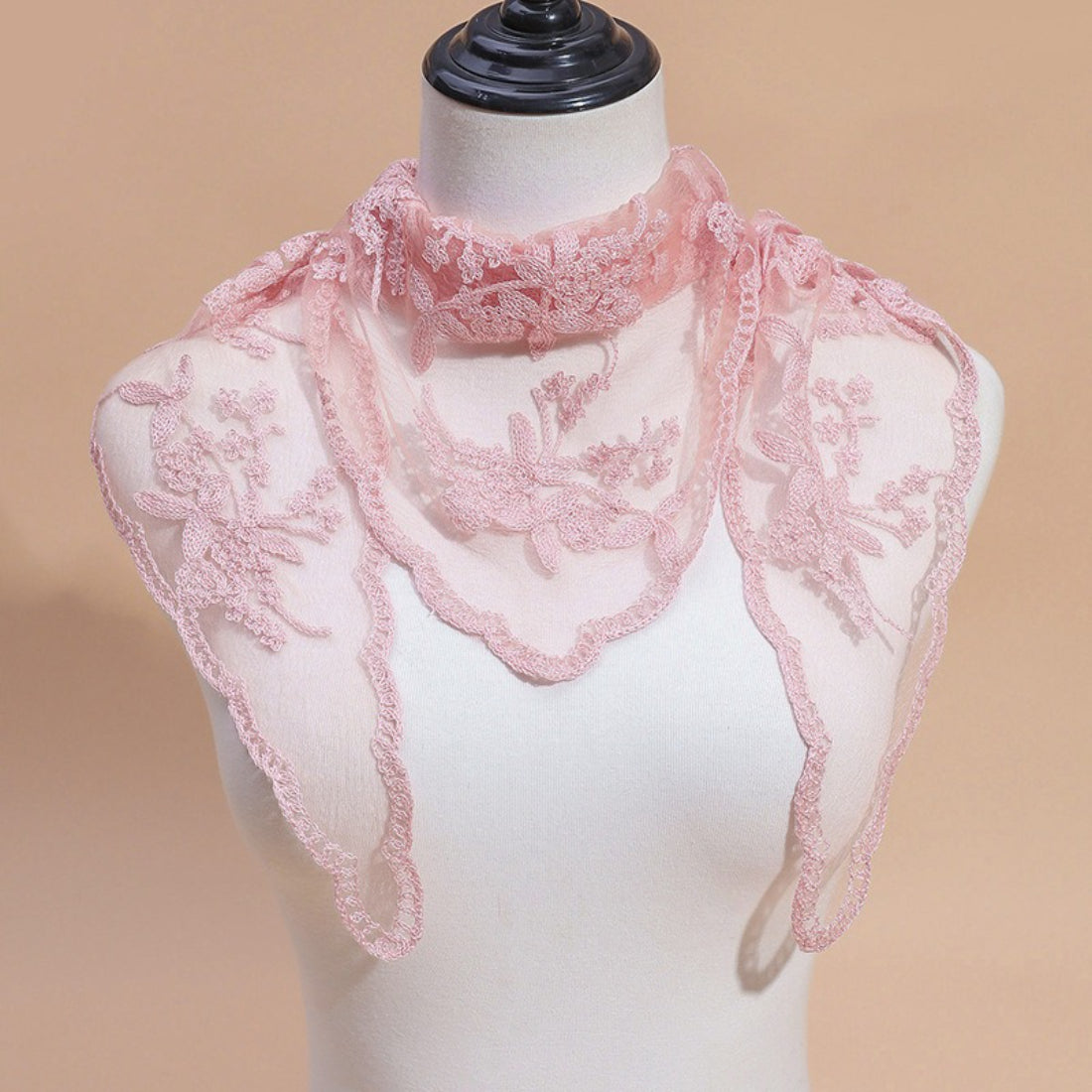 Model adjusting Haila embroidered lace veil head scarf in natural light