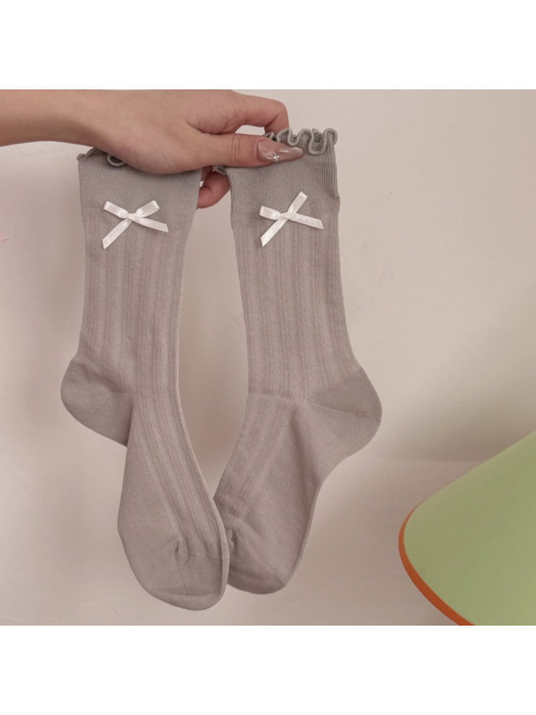 Model wearing Rufia soft bow frill crew socks paired with casual shoes