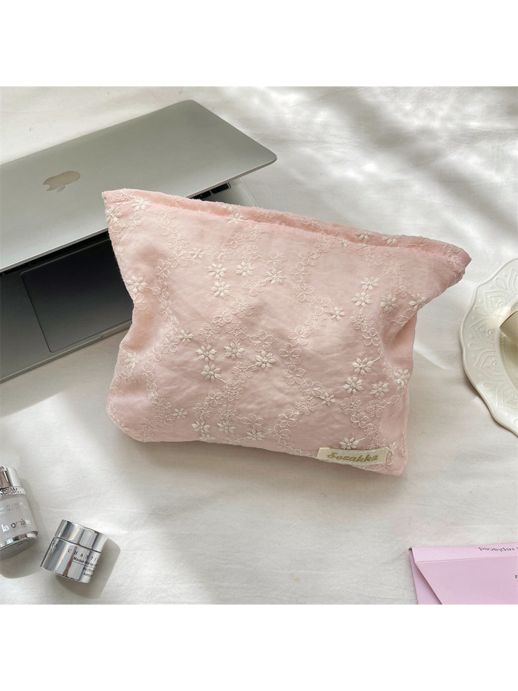 Side view of Cosbai floral embroidered cosmetic pouch highlighting