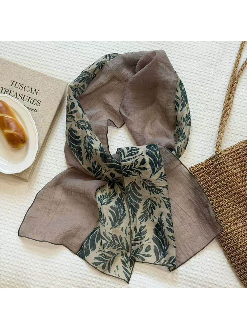 Model tying lightweight patchwork neck scarf in a stylish knot
