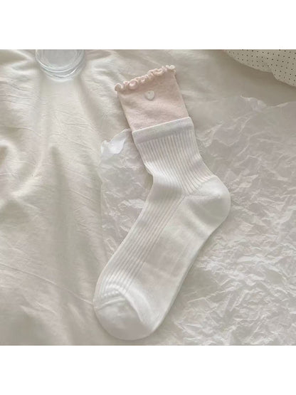 Close-up of bow detail on Rufia Romantic Bow Texture crew socks in pastel color