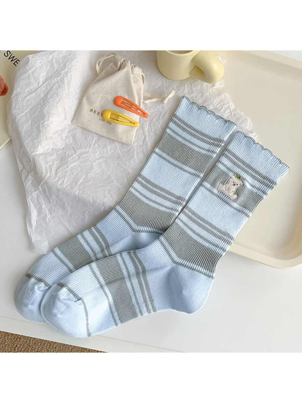 Model wearing Rufia Soft Stripe Bear Crew Socks with beige and brown stripes
