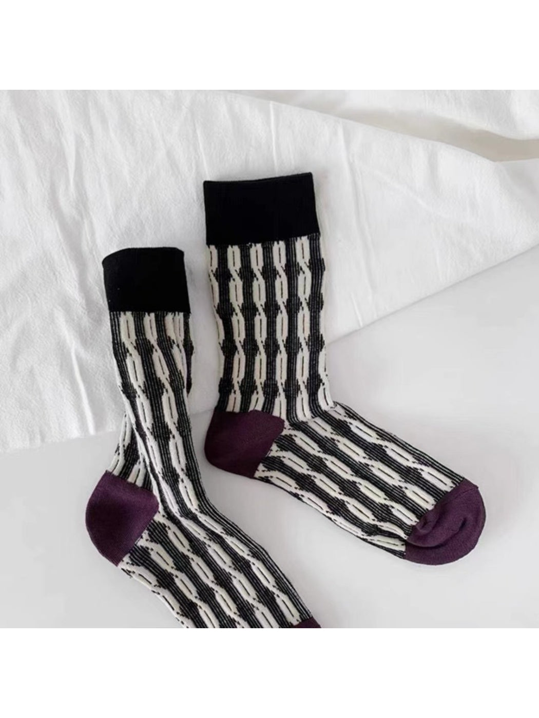 Side view of Rufia graphic knit crew socks on a model's feet
