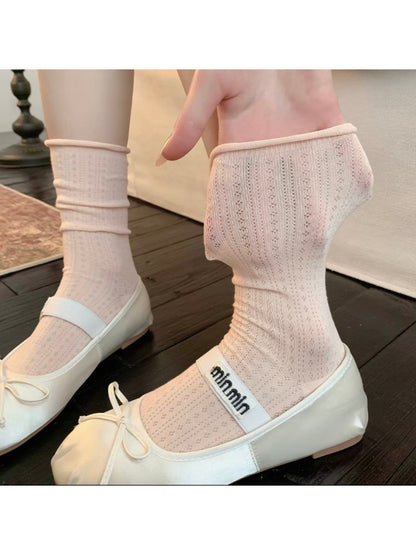Rufia ribbed mid-calf socks paired with casual footwear