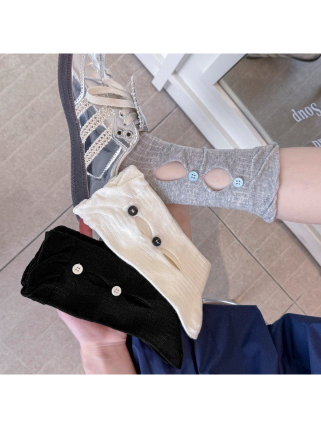 Side view of Rufia button cut out crew socks in white highlighting cut out design