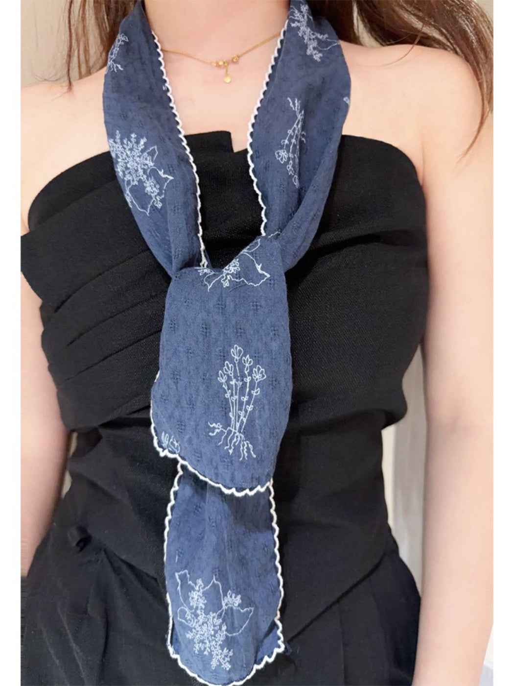 Scarvii Floral Stitch Narrow Scarf rolled up displaying fabric texture and embroidery