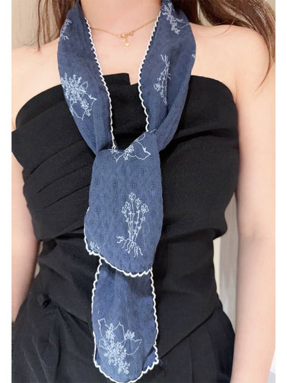 Scarvii Floral Stitch Narrow Scarf rolled up displaying fabric texture and embroidery