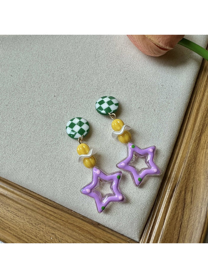 Close-up of a pair of silver star-shaped charm earrings with a playful design
