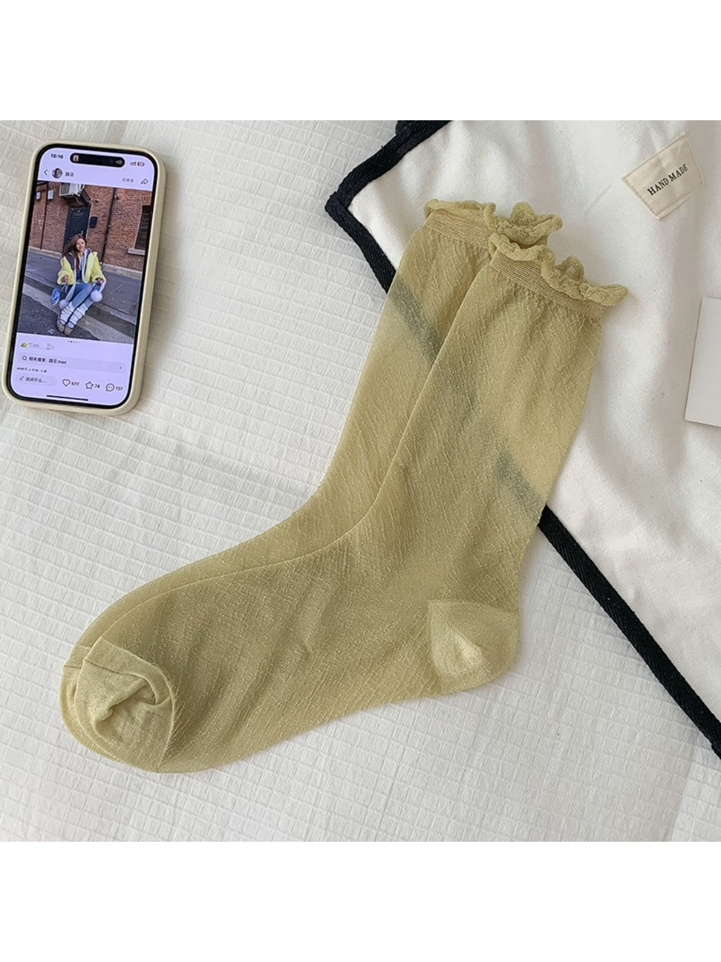 Rufia socks folded neatly highlighting soft sparkle yarn and ribbed cuff