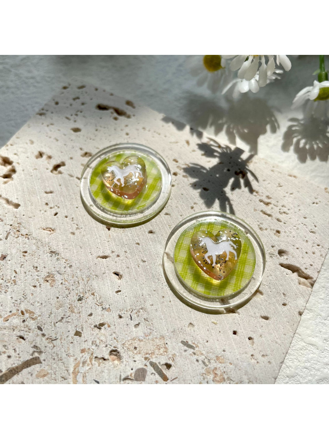 Model wearing green check horse earrings with short hair