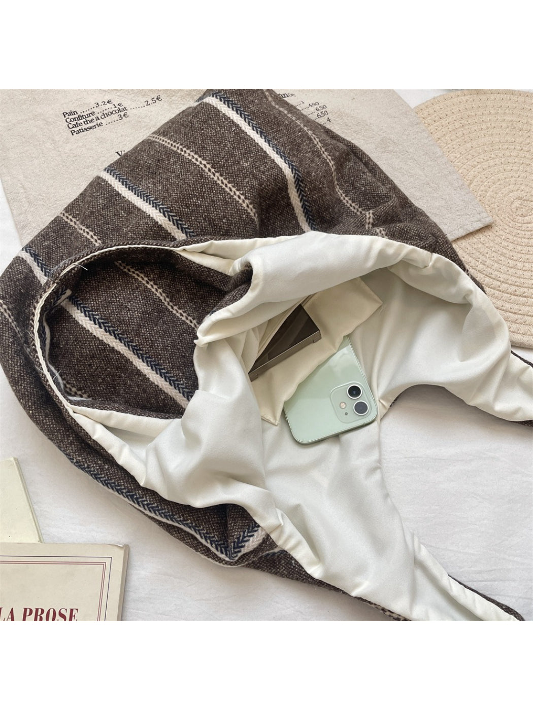 Side view of Cosbai vintage stripe slouchy tote bag highlighting its soft structure and striped design