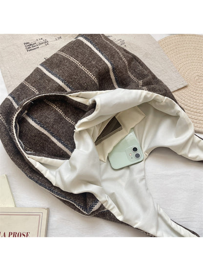 Side view of Cosbai vintage stripe slouchy tote bag highlighting its soft structure and striped design
