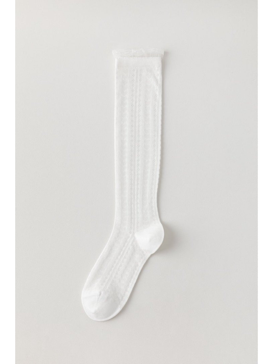 Close-up of ribbed cuff and cable knit detail on Rufia knee high sock