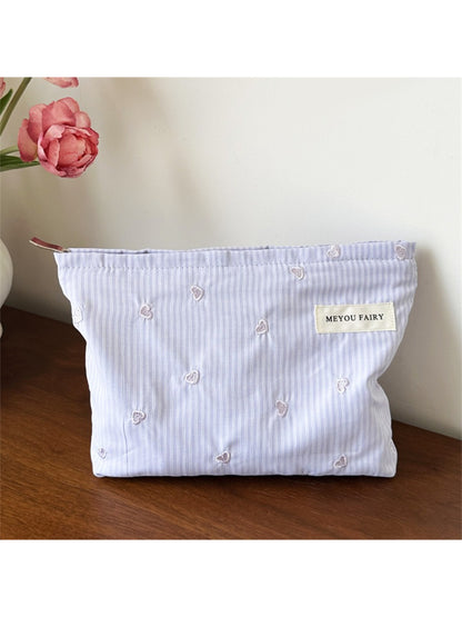 Cosbai makeup organizer bag with cosmetics and brushes inside, demonstrating capacity