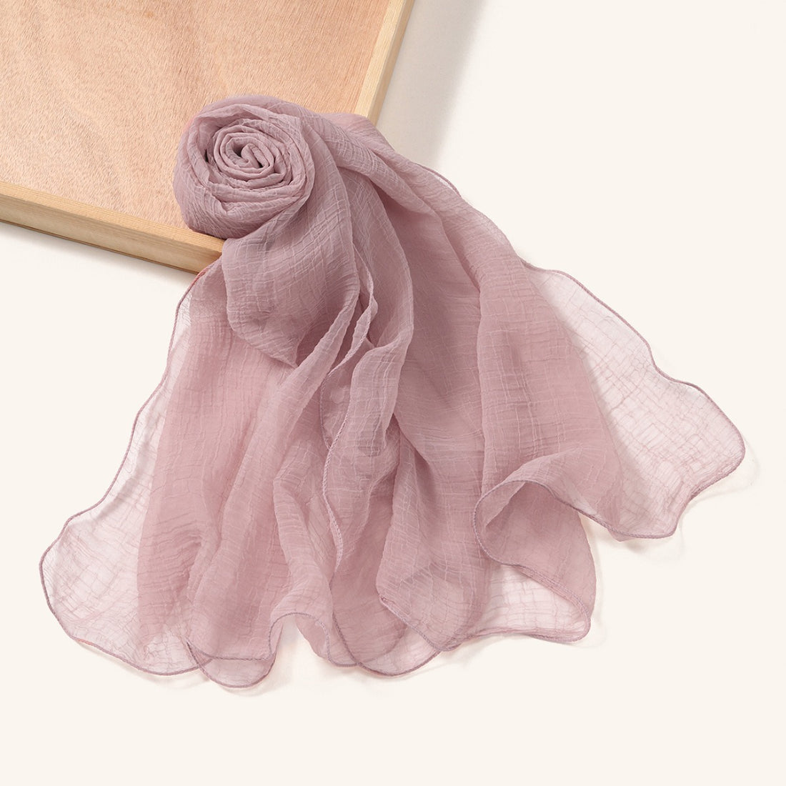 Model adjusting Scarvii textured shawl scarf with wavy edges outdoors