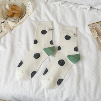 Rufia socks folded to show contrast heel and black dot pattern on white fabric