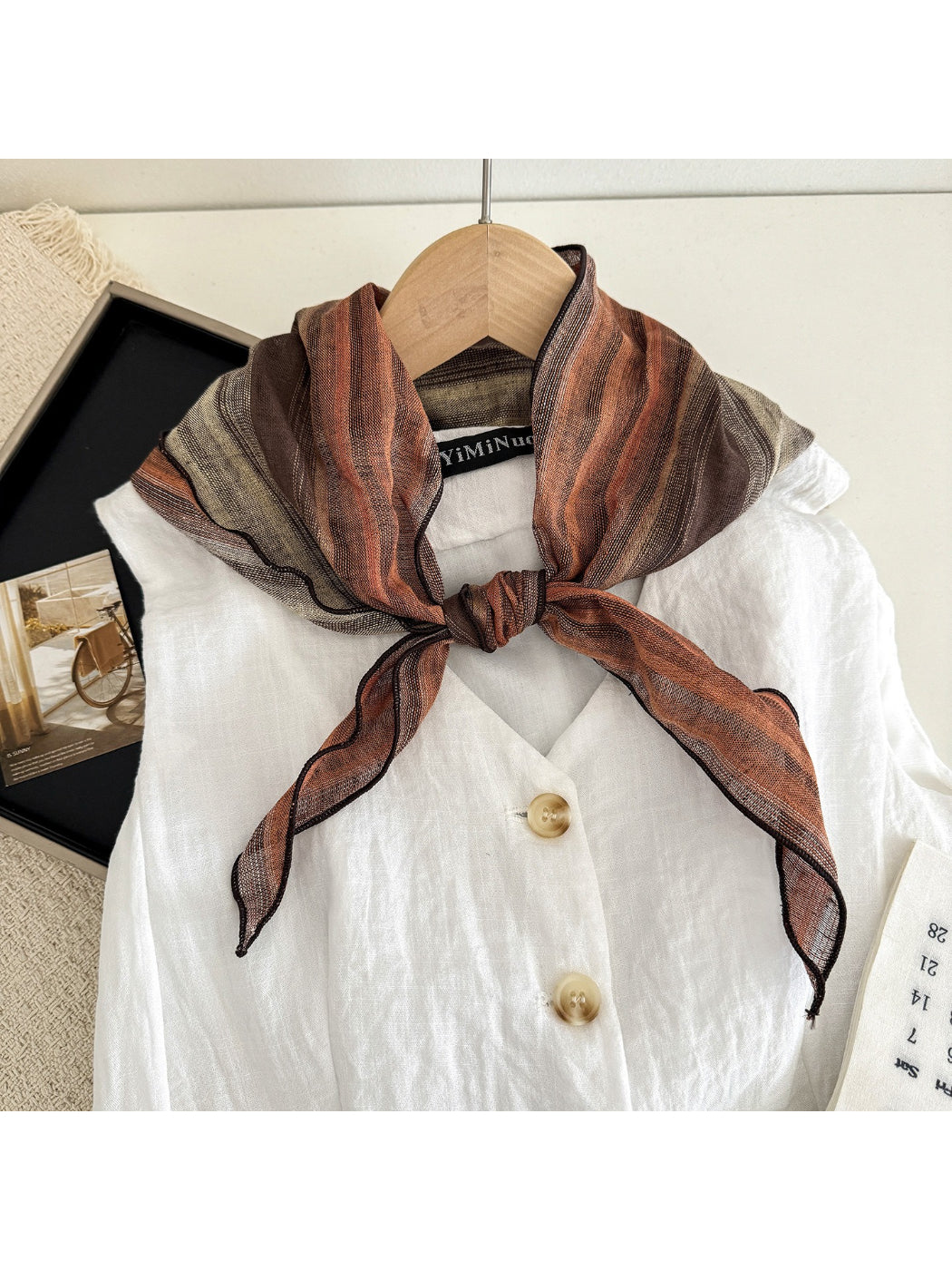 Sheer gradient neck triangle scarf draped on a mannequin showing soft color transition