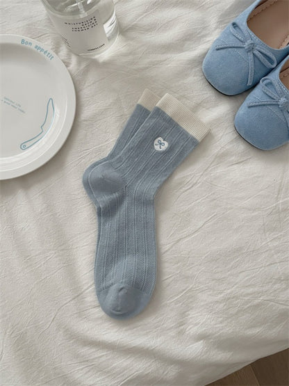 Rufia floral crew socks folded neatly with visible floral design and knit details
