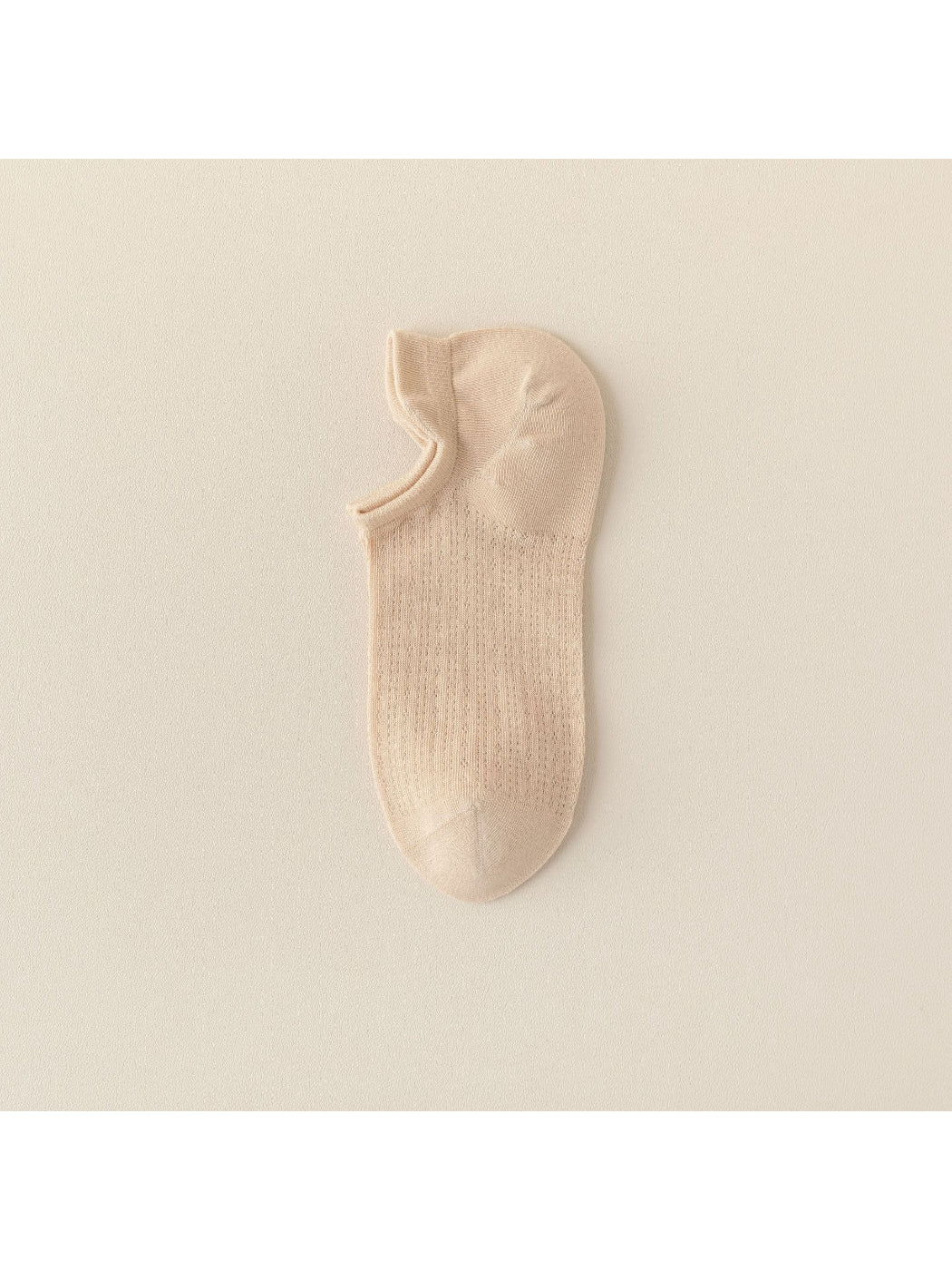 Close-up of sock heel and toe area of beige liner sock