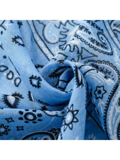 Scarvii wrap spread out flat displaying full paisley patchwork pattern and tassel edges