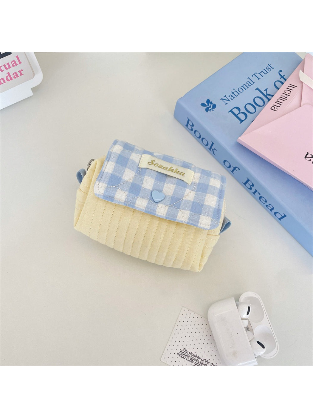 Top view of Cosbai gingham quilted cosmetic pouch partially open