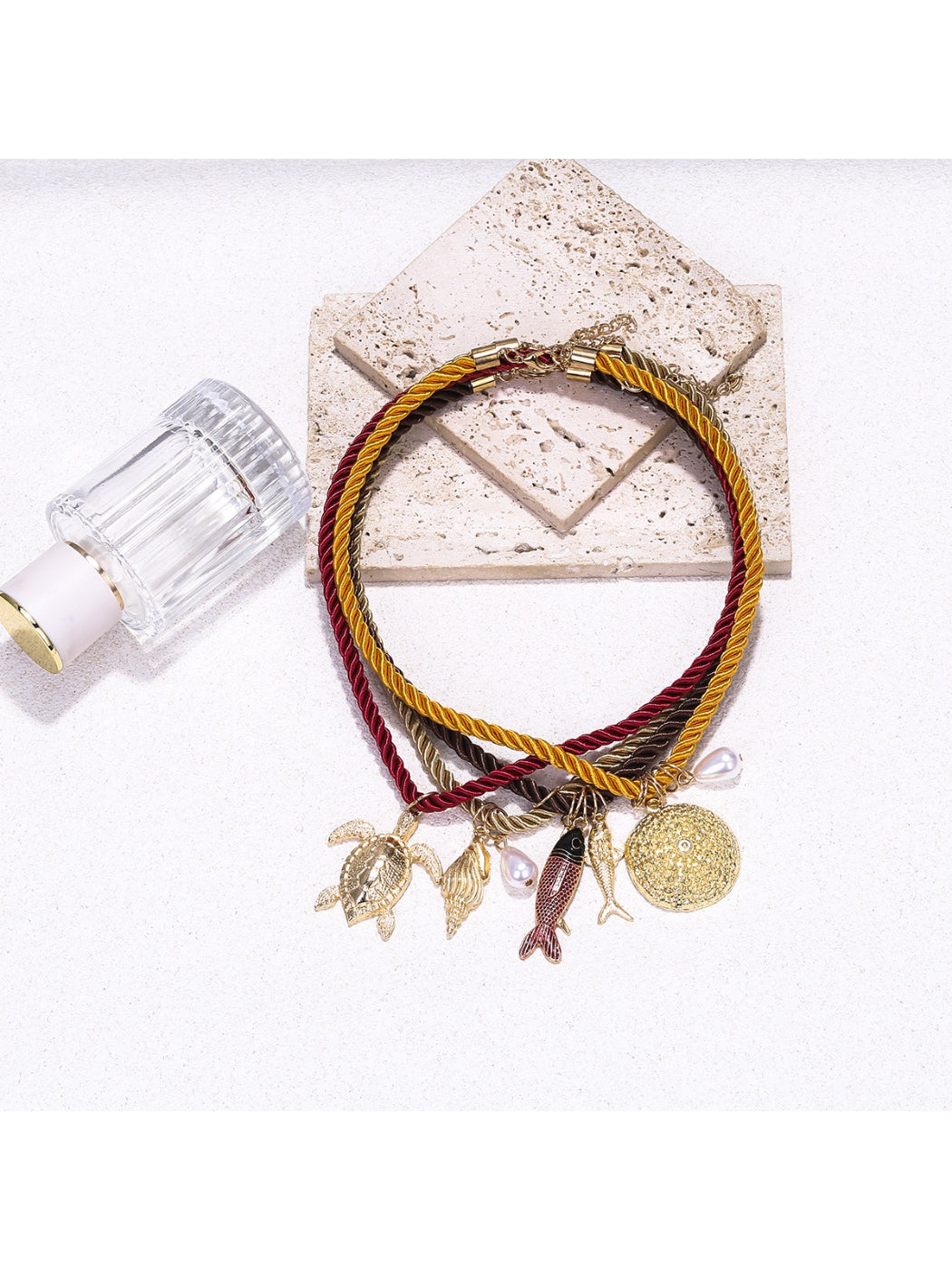 Neckit multi strand rope necklace featuring ocean-themed charms on a white background