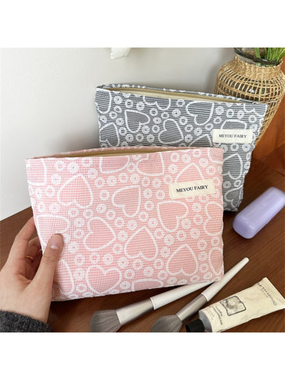 Close-up of heart pattern on Cosbai makeup bag showing small and large pink hearts