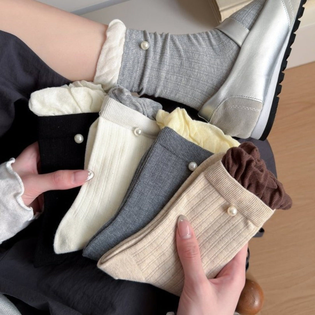 Pair of Rufia ribbed crew socks with ruffle accent in soft beige color