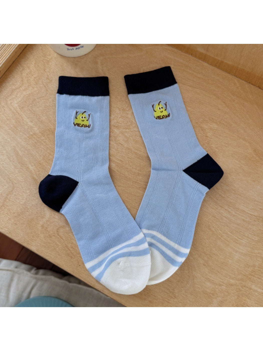 Top view of Rufia socks displaying vibrant fruit motifs and ribbed cuffs