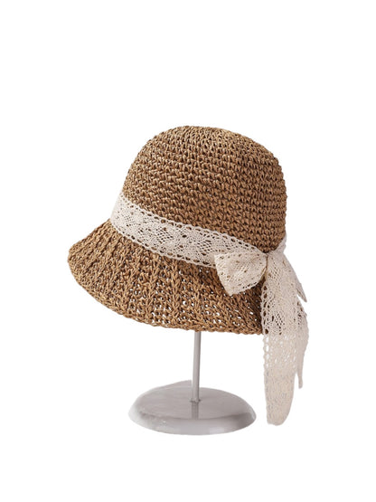 Side view of Haila straw sun hat showing woven texture and lace bow