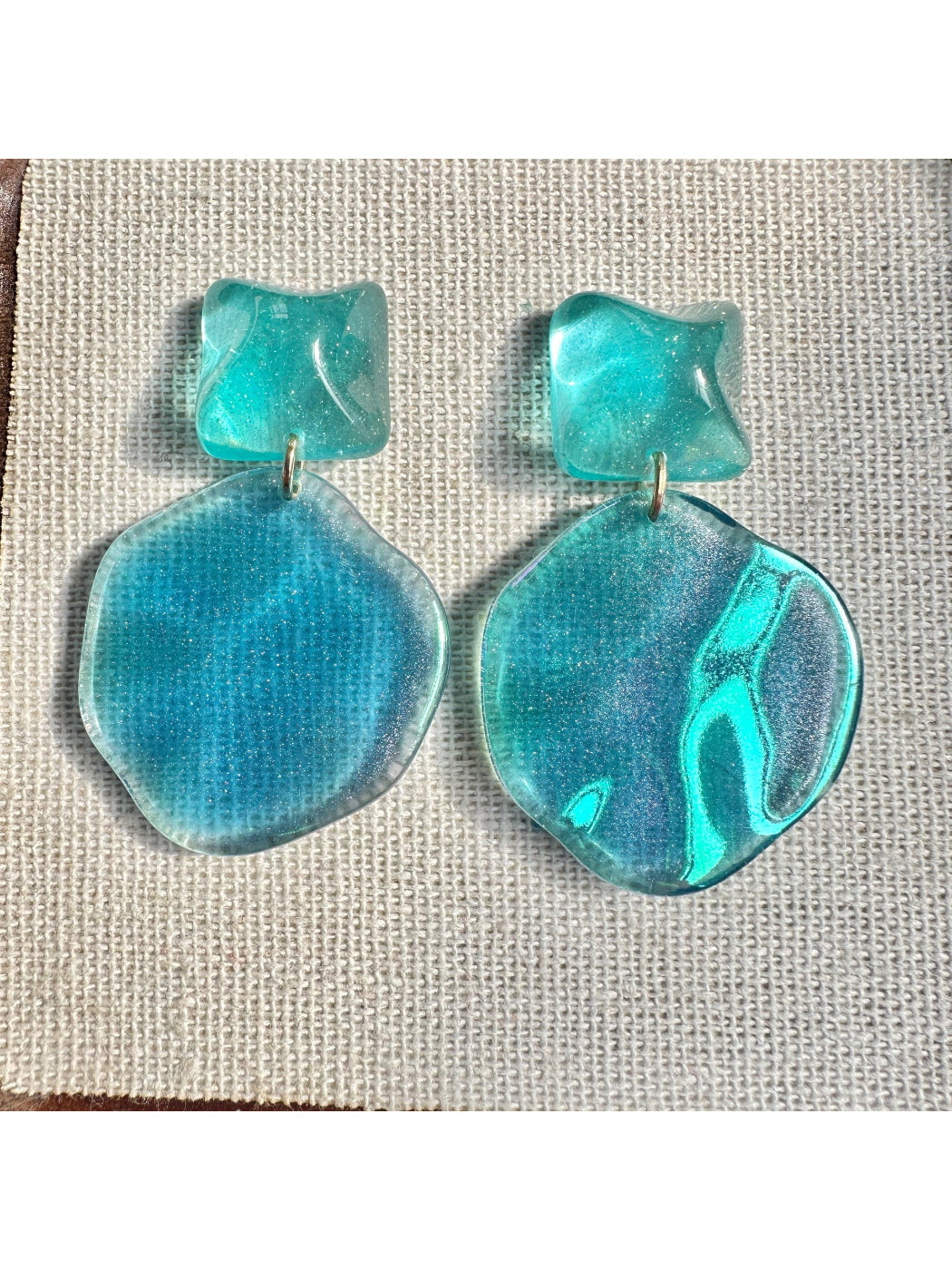 Model wearing Earwish ocean blue drop earrings with silver hooks