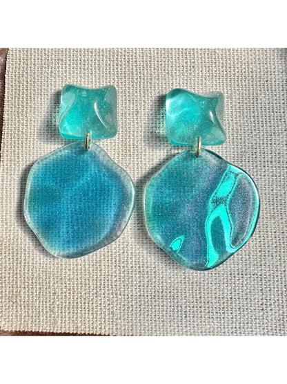 Model wearing Earwish ocean blue drop earrings with silver hooks
