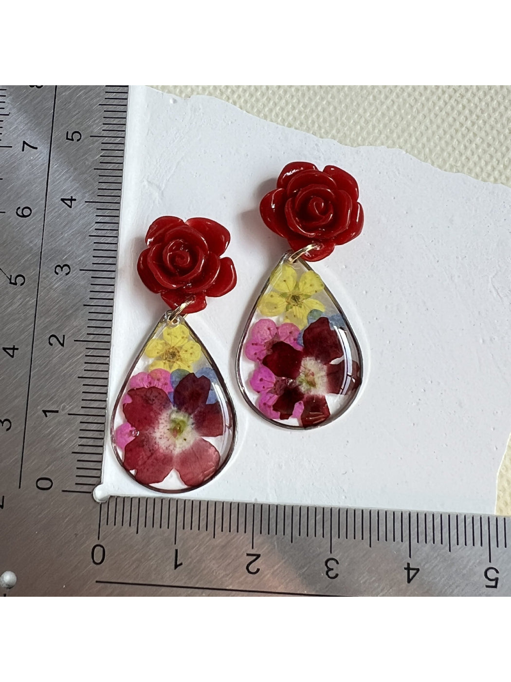 Earwish Rose Teardrop Earrings displayed on a white jewelry stand
