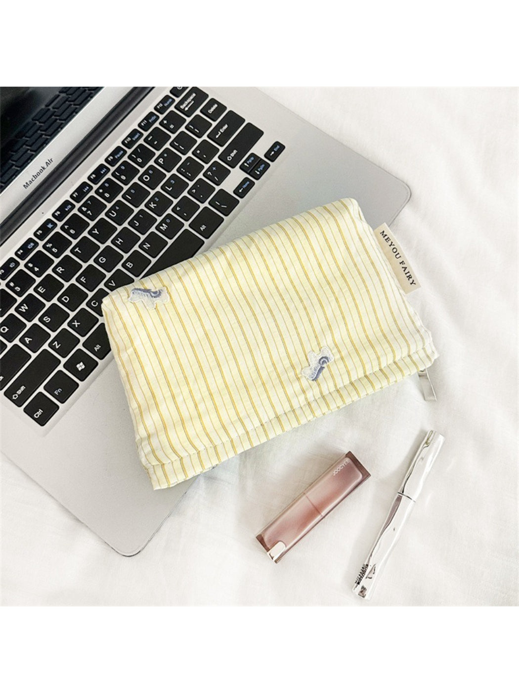 Cosbai Soft Stripe Makeup Pouch next to matching cosmetic accessories