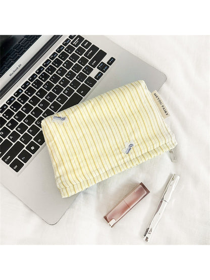 Cosbai Soft Stripe Makeup Pouch next to matching cosmetic accessories