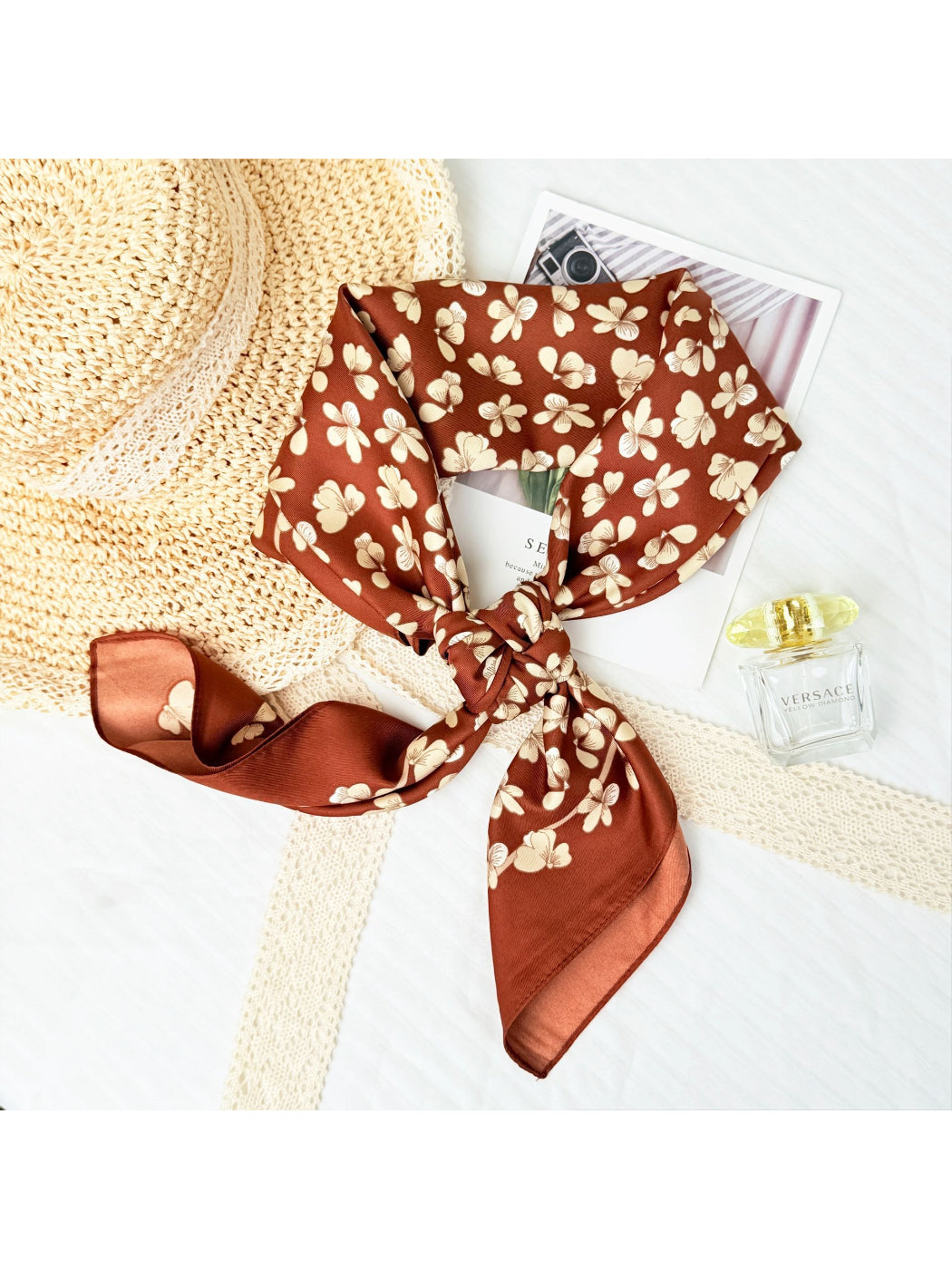 Model wearing small floral neck square scarf tied around the neck with casual outfit