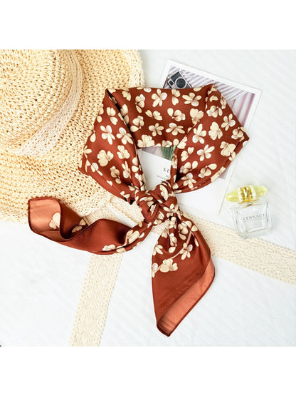 Model wearing small floral neck square scarf tied around the neck with casual outfit