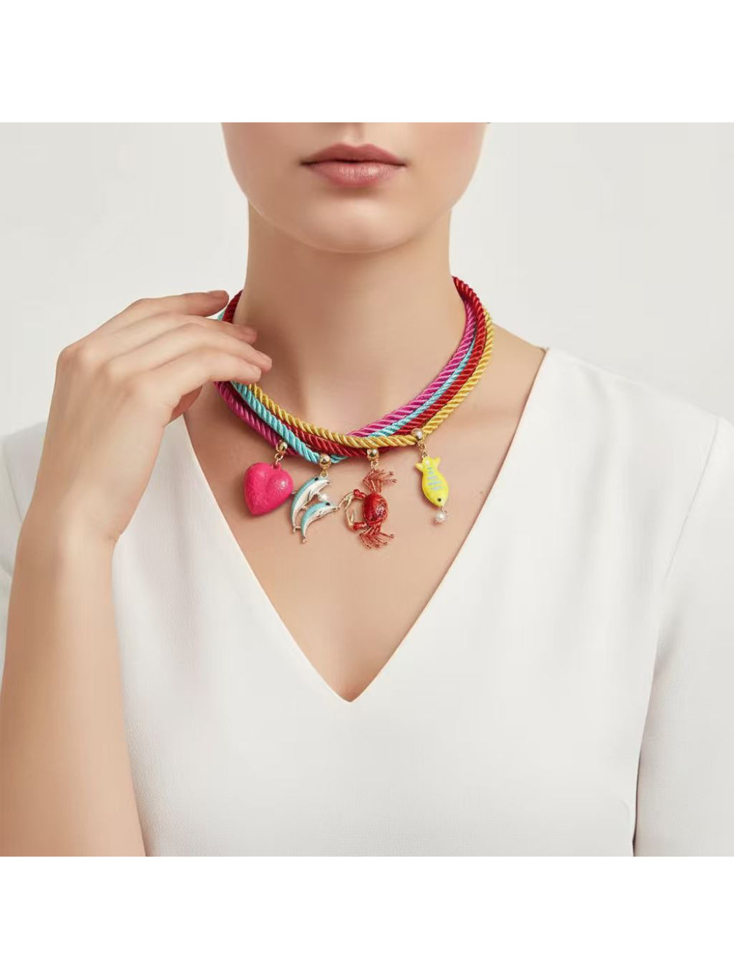 Colorful rope necklace featuring ocean-themed charms displayed on a white background
