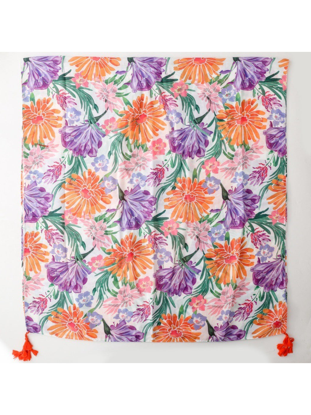 Model wearing Scarvii Tropical Bloom Tassel Scarf styled around the neck with tassels visible