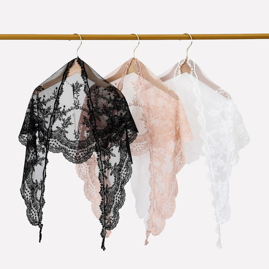 Haila Baroque lace triangle veil scarf draped over a mannequin head