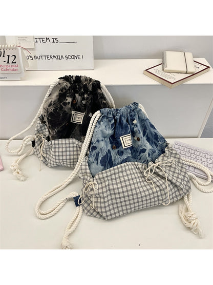 Close-up of Cosbai backpack's patchwork design and drawstring closure detail