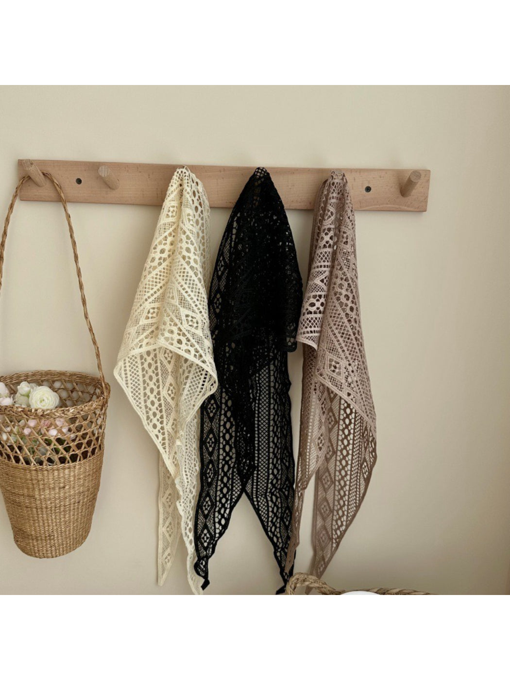 Boho crochet triangle headscarf in cream color styled on a mannequin