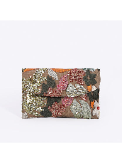 Cosbai clutch bag held in hand to show size and scale