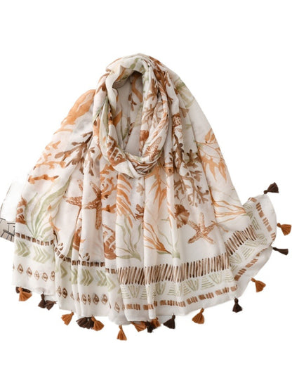 Model wearing Coastal Starfish Tassel Scarf draped around neck outdoors