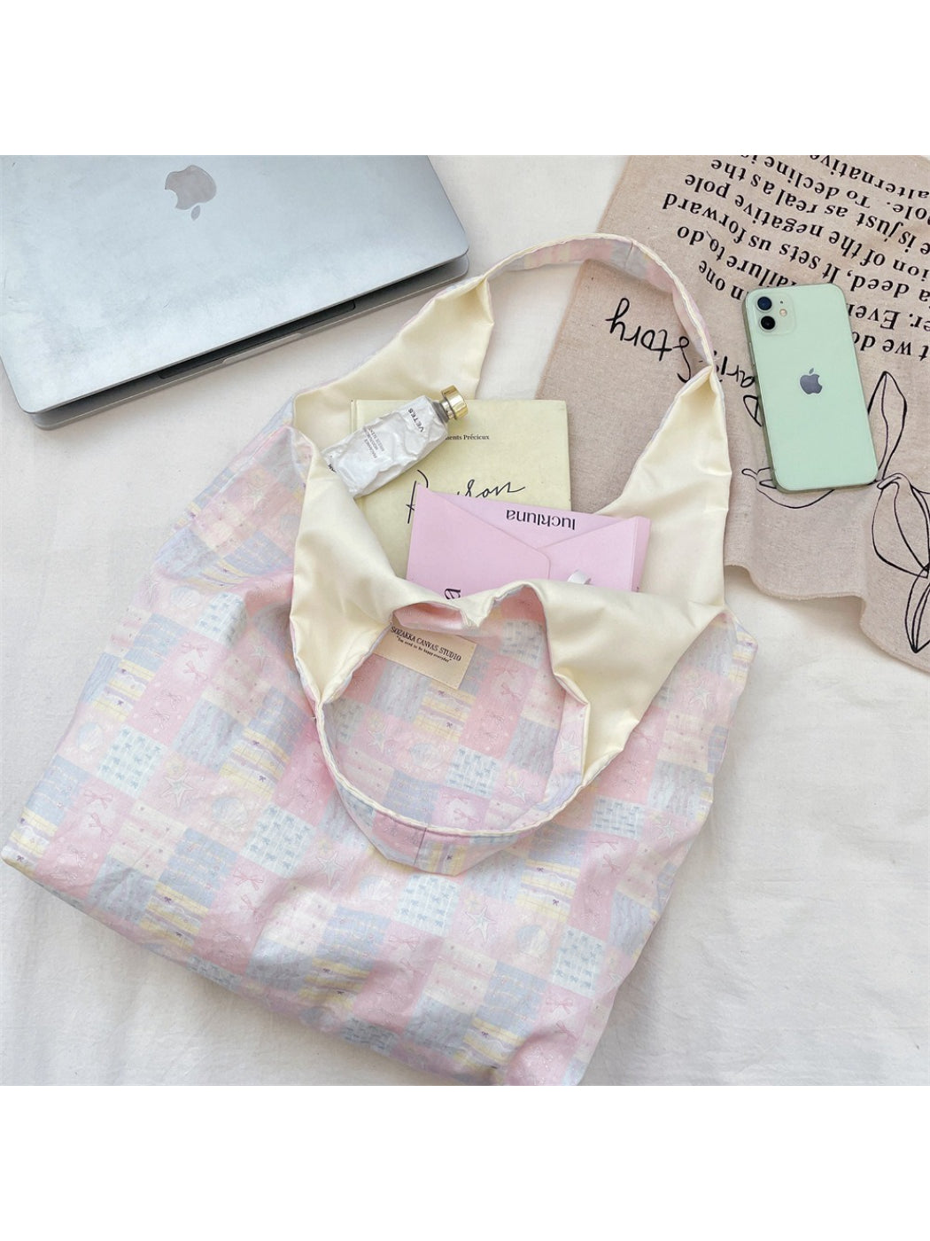 Close-up of Cosbai tote bag showing patchwork stitching and slouchy design