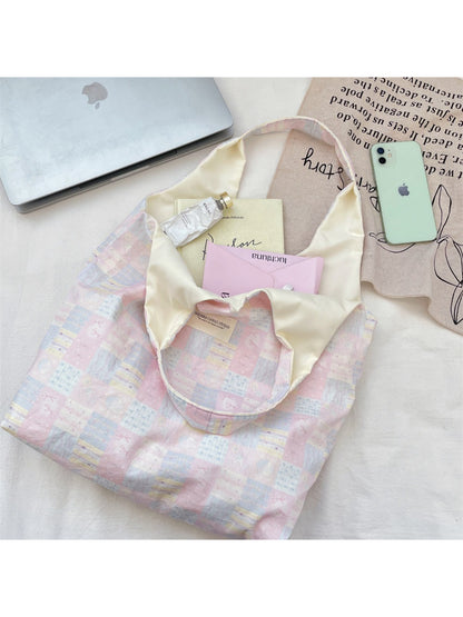 Close-up of Cosbai tote bag showing patchwork stitching and slouchy design