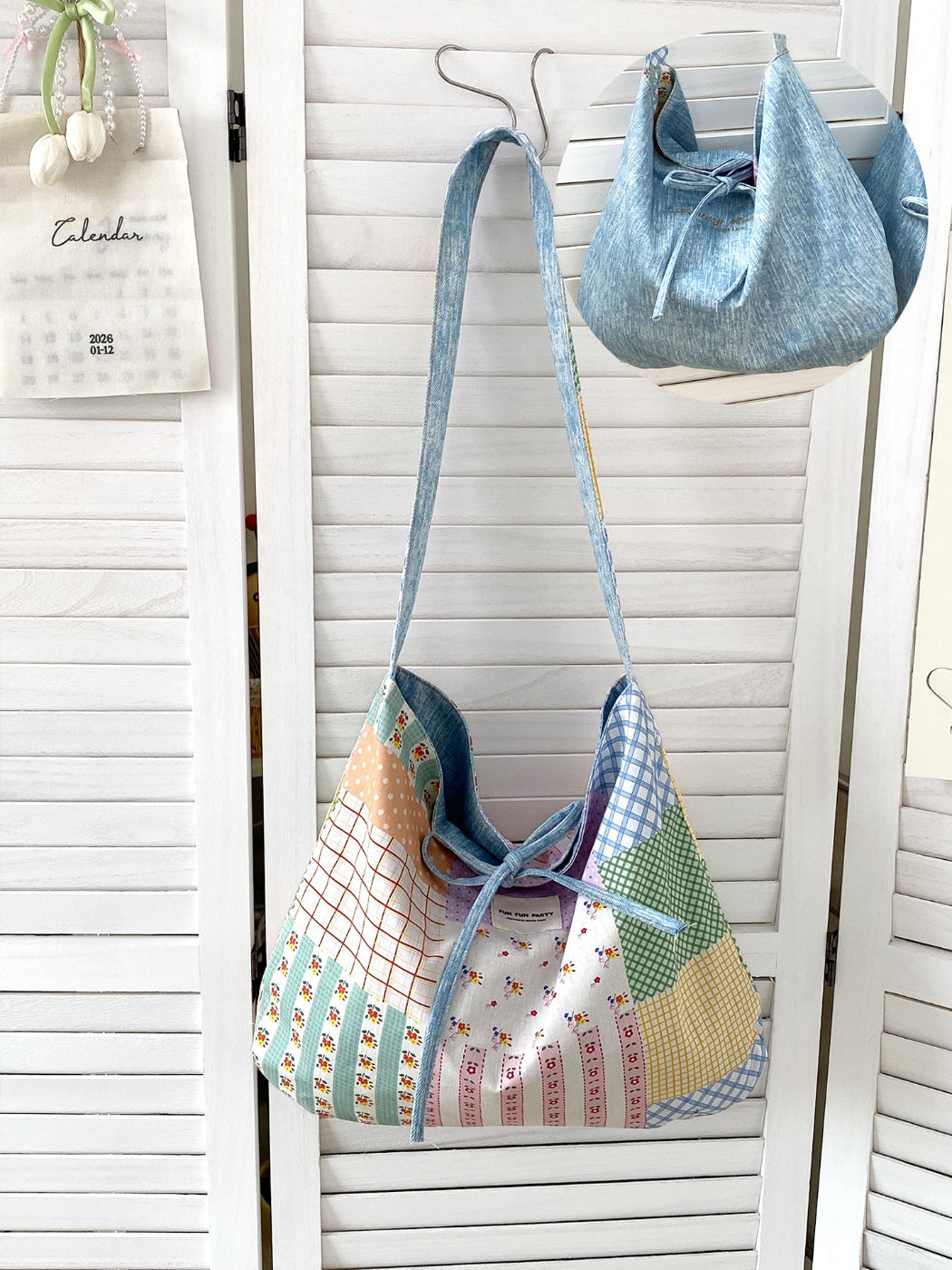 Side view of Cosbai reversible patchwork shoulder bag showing slouchy shape