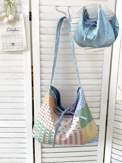 Side view of Cosbai reversible patchwork shoulder bag showing slouchy shape