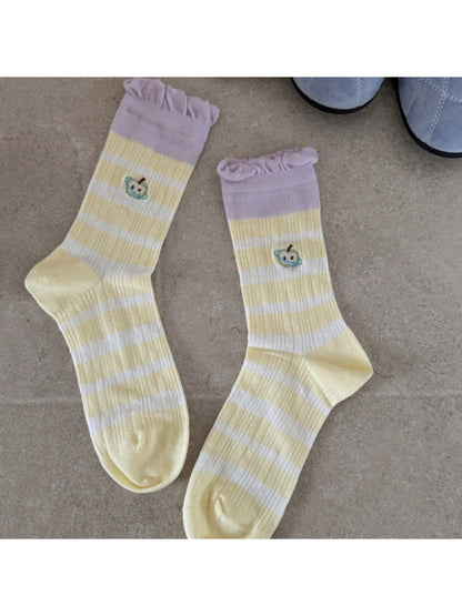 Rufia mid-calf socks worn on both feet with visible lace embroidery and mesh texture